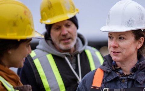 Construction workers discussing safety procedures on site