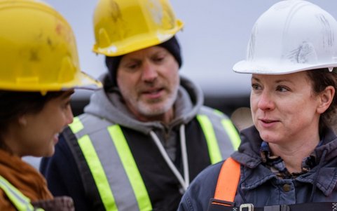 Construction workers discussing safety procedures on site