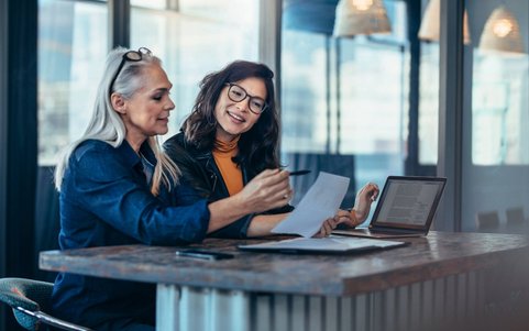 Two women having a conversation in the office